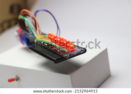 Glowing red light-emitting diodes from an electronic project circuit. Red LED lights glowing Royalty-Free Stock Photo #2132964915