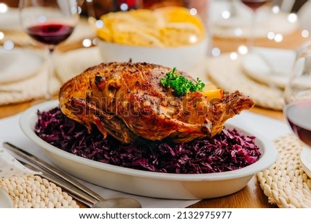 Oven roasted duck - whole baked duck with red cabbage and potato pancakes Royalty-Free Stock Photo #2132975977