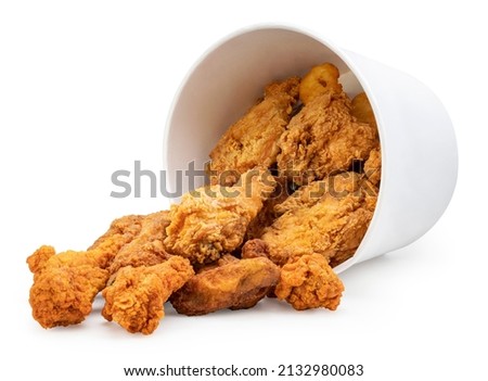 Fried chicken drop from falling paper bucket isolated on white background, Deep fried Chicken in paper bucket on white With clipping path. Royalty-Free Stock Photo #2132980083