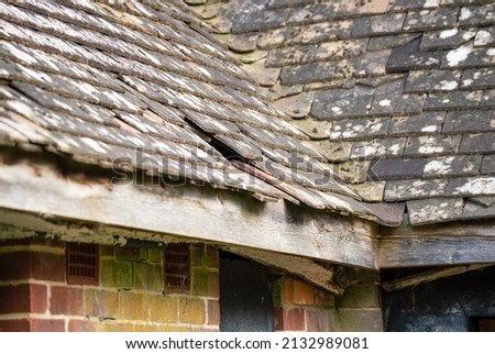 an old tiled roof damaged by recent storm weather