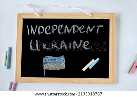 inscription in chalk on a blackboard Ukraine independence and Ukrainian flag