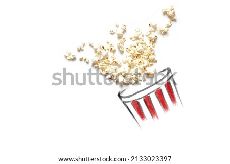 popcorn falling out from red and white color bucket