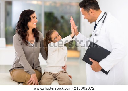 happy little girl and paediatrician doing high five after medical checkup Royalty-Free Stock Photo #213302872