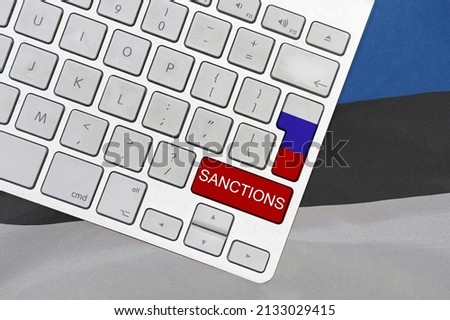 White computer keyboard with button of flag Russia and red button with word of sanctions on Estonia flag background. Financial and economic regulation sanctions Estonia against of Russia