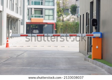 automatic barrier for home village security system. Automatic barrier arm for car park of resident. Royalty-Free Stock Photo #2133038037