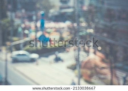 The Blurred image of a car driving on the road Traffic and bokeh from the melting of the len 
used. for scene background or wallpaper and design work.