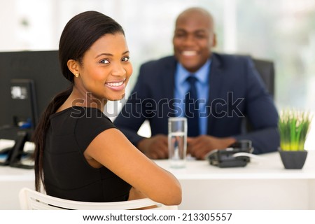 attractive african office worker looking back Royalty-Free Stock Photo #213305557