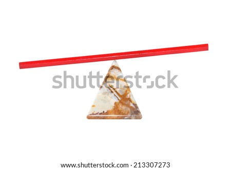 Red pencil on pyramid made from semiprecious stone on white background. Clipping path is included