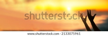 Worship and prayer banner. Christian worship and praise. A young woman is praying and worshiping in the evening.  Royalty-Free Stock Photo #2133075961