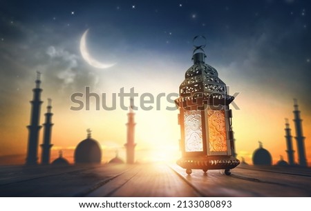 Ornamental Arabic lantern with burning candle glowing at night. Festive greeting card, invitation for Muslim holy month Ramadan Kareem. Royalty-Free Stock Photo #2133080893