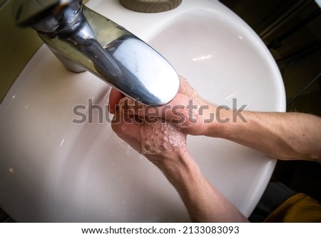 Man washing his hands in the washbasin