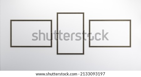An empty wall with blank picture frames