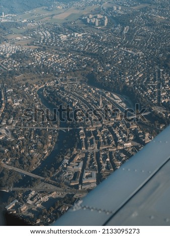 A vertical shot of a city landscape seen from an airplane