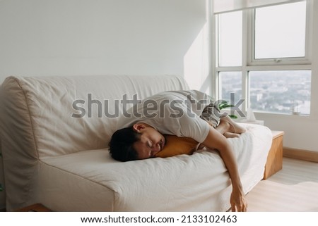Lonely single sick Asian man sleep and isolated in his apartment. Royalty-Free Stock Photo #2133102463