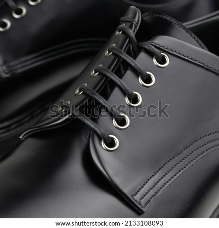 Black leather derby lacing with metal eyelets closeup