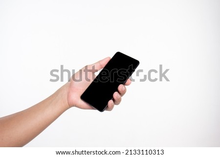 The empty  hand makes a gesture like holding something isolated in hand behind a white background.