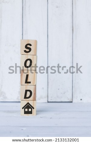 sold word or concept on wooden blocks, white wood background