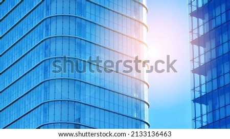 Glass facade of a modern housing construction with of balconies. Velvia photo filter.