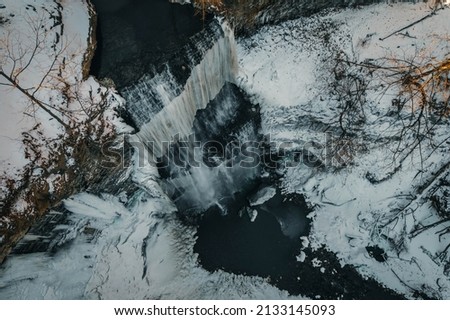 Aerial view of a waterfall in winter.