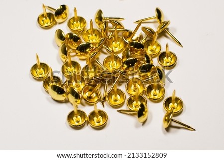 Decorative brass nails on an isolated white background.