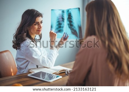 Doctor diagnosing patient’s health on asthma, lung disease, COVID-19, coronavirus or bone cancer illness with radiological chest x-ray film for medical healthcare hospital service