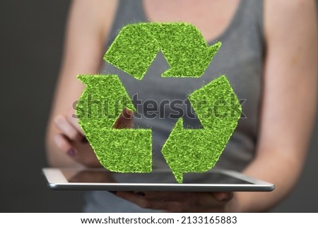 A person presenting a virtual projection of recycling symbol