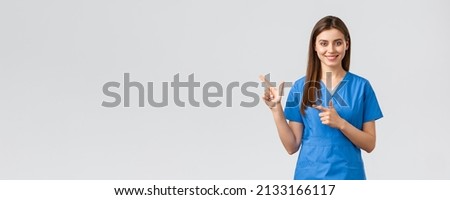 Healthcare workers, prevent virus, insurance and medicine concept. Professional smiling, attractive female nurse or doctor in blue scrubs, physician pointing finger left at banner, recommend clinic