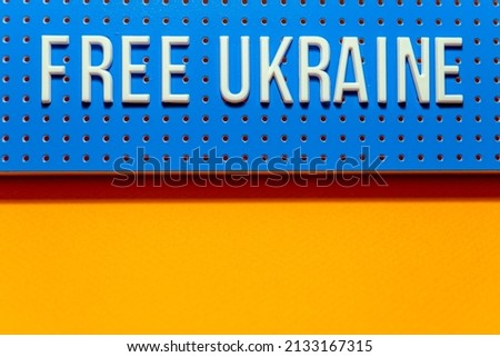 Free Ukraine supporter banner on a blue background.