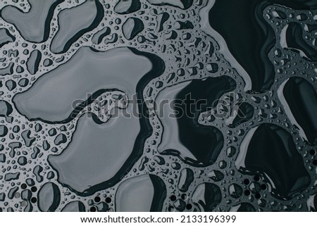 Water drops on black surface background. Raindrops for overlaying on window, concept of autumn weather,