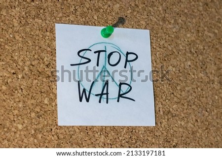 Words stop war and peace sign on corkboard
