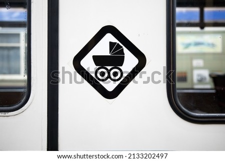 View of baby buggy sign on public transport