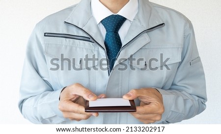 A businessman exchanging business cards. Men in work clothes.