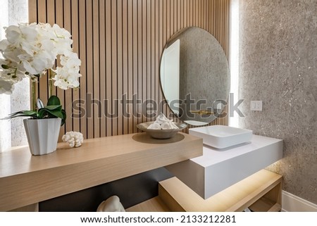 powder room with slatted wood walls orchid square sink and soft wood tones Royalty-Free Stock Photo #2133212281