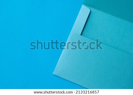 Open envelope isolated on blue background.