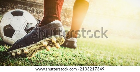 close up feet of soccer football player dribbling the ball in stadium during match  Royalty-Free Stock Photo #2133217349