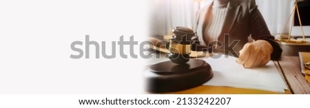 
Male lawyer working with contract papers and wooden gavel on tabel in courtroom. justice and law ,attorney, court judge, concept.
