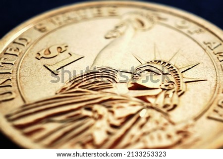 Fragment of American one dollar coin. Statue of Liberty and the sign of national currency. US economy and money. USA public debt and treasurys. Macro Royalty-Free Stock Photo #2133253323