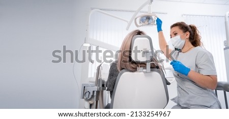 young caucasian woman dentist and patient. Dentist lifestyle scene. Doctoral practice. Patient healthcare. Banner. copy space. Royalty-Free Stock Photo #2133254967