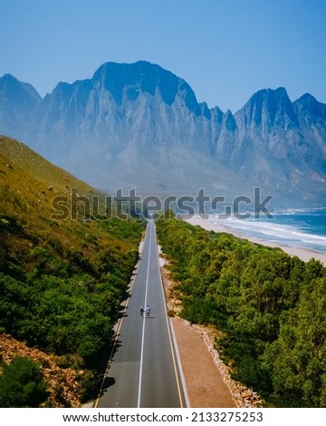 Kogelbay beach Western Cape South Africa, Kogelbay Rugged Coast Line with spectacular mountains. Garden route.couple man and women walking on road, drone view Royalty-Free Stock Photo #2133275253