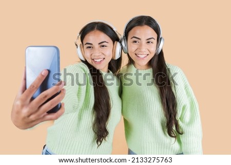beautiful women twin sisters make a selfie