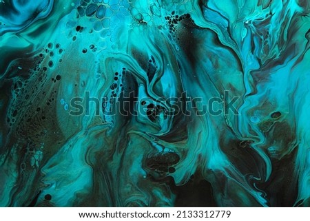 Fluid Art. Green and blue abstract wave swirls on black background. Marble effect background or texture