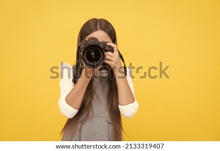 happy teen girl photographer taking picture with digital photo camera, copy space, photographing Royalty-Free Stock Photo #2133319407