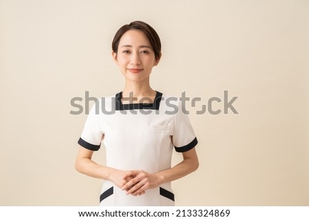 Pretty Asian woman in uniform Royalty-Free Stock Photo #2133324869