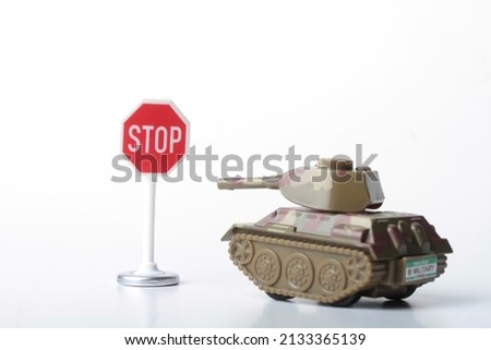 war tank in front of a stop sign