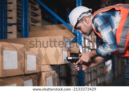 Logistic distribution center or Inventory hub warehouse concept, Male worker working stock check at store Royalty-Free Stock Photo #2133373429