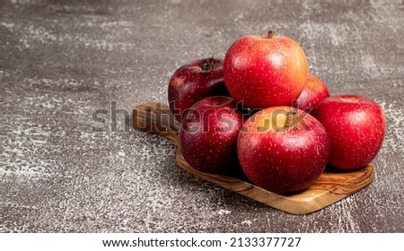 Fresh red apples on a brown table. Free space for text, stock photo