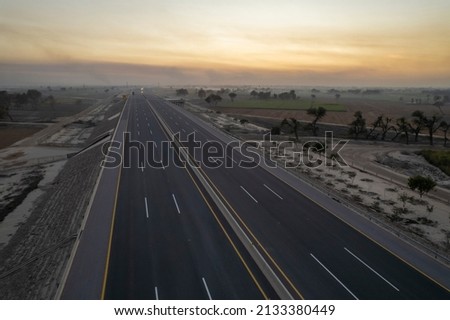 a sunset on the motorway Royalty-Free Stock Photo #2133380449