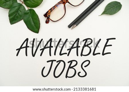 Writing displaying text Available Jobs. Conceptual photo a job that is available for someone to start doing Vacancy Office Supplies Over Desk With Keyboard And Glasses And Coffee Cup For Working