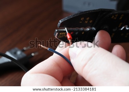 Hand crimping pliers for electrical connectors. Small cable end-sleeves ferrules. Royalty-Free Stock Photo #2133384181