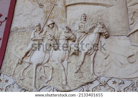 The Madara Rider is an early medieval large rock relief-Bulgaria-UNESCO World Heritage Site-Detail from wall art in the City Palace-Sand stone sculpture brick wall of herd horse run background,